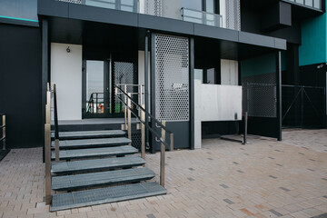 modern front door porch at the entrance and a lift for disabled people