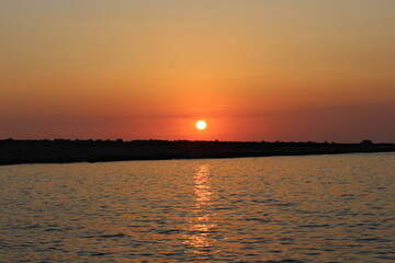 Orange Sunset above the horizon of the sea in the mediterranean on the maltese archipelago