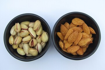 Almonds and pistachios in bowls 
