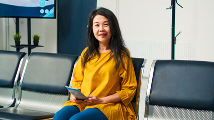 Portrait of senior asian woman in hospital waiting room having checkup appointment with physician....
