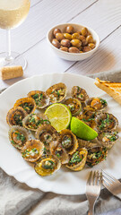 Patella, Limpets with lime on white plate - traditional seafood of Tenerife and Madeira Islands.