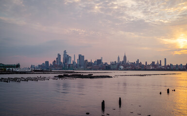New York Manhattan skyline at sunset reflection river 