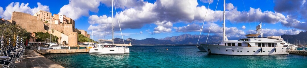Calvi town, Corsica. Panorama of marine with sailing boats and medieval fortess. France