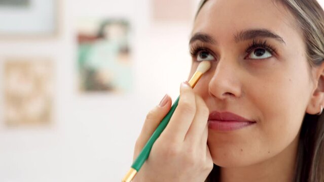 Woman, do makeup and eye for beauty, salon or studio for cosmetics with smiling girl. Lady, face and brush to look beautiful as model, smile and happy with look from makeup artist working on skin