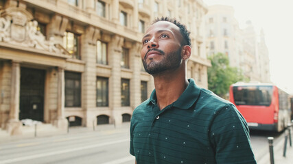 Young man walking down the street on the old town background