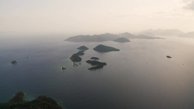 Aerial view of island on open sea with unique formation, top view of tersane island of gocek with clouds on horizon