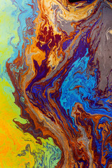 Fototapeta na wymiar Abstract pattern in oil spilled in small stream, Costa Rica