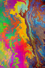 Fototapeta na wymiar Abstract pattern in oil spilled in small stream, Costa Rica