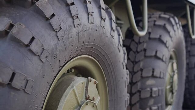 Close-up of moving wheels on a military armored car. Shooting equipment in motion
