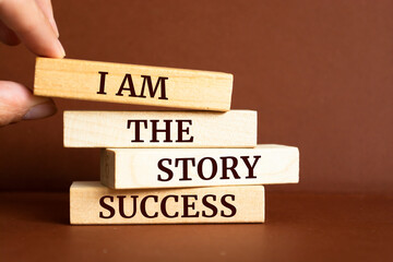 Wooden blocks with words 'I Am The Story Success'.