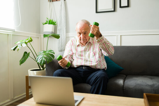 Healthy Old Man Working Out And Watching Exercise Videos