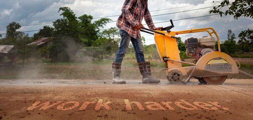 Construction workers operate concrete road cutters. Cut roads at rural construction sites and...