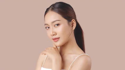 Fotobehang Studio shot of Beautiful young Asian woman with clean fresh skin on brown background, Face care, Facial treatment, Cosmetology, beauty and spa. © RedcupStudio