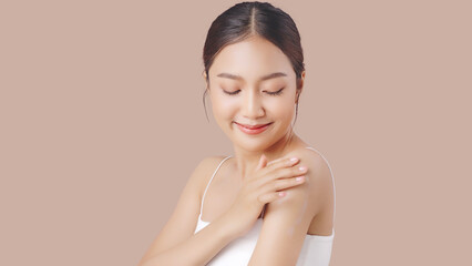 Close up perfect beauty face of young beautiful Asian woman applying moisturizer cream on her...