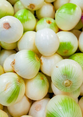 pile of onions on the shelf of the super market