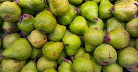 stack of pears on the supermarket shelf