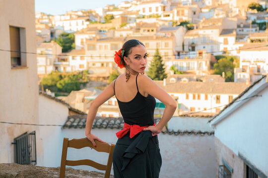 Woman dressed as a flamenco dancer in a street in Cazorla, Spain