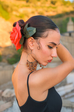 Woman puts a red flower in her hair