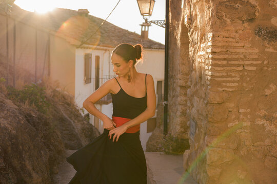 Woman dances flamenco at sunset