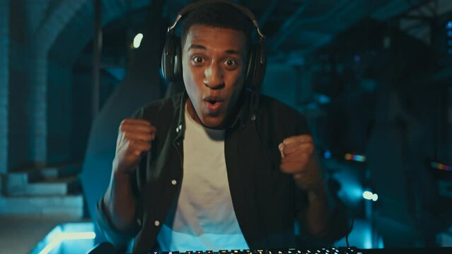 A man plays computer games while playing in a computer club. Emotion of joy, happiness.