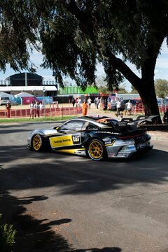Vertical shot of a Porsche Carerra on a road at Albert Park, getting ready for the F1 Grand Prix