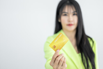 Asian woman holding credit card on white background, Asian woman showing presenting credit card, Woman holding bank business credit card with copy space.