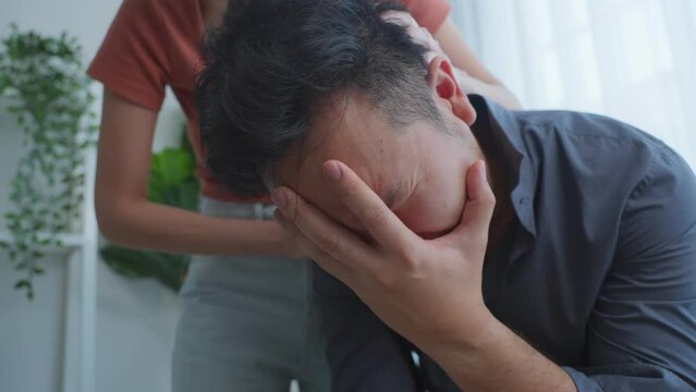 Asian young wife comfort upset husband crying with tears for problem. 