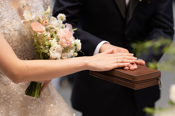 Bride and Groom with hands on bible