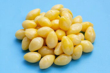 Boiled ginkgo nuts on blue background.