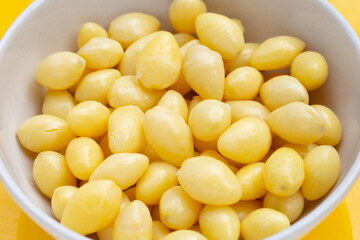 Boiled ginkgo nuts on yellow background.