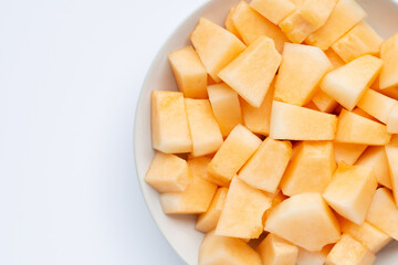 Cantaloupe melon in plate on white background.
