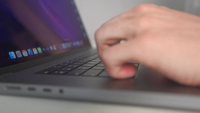 a close-up of hands that.being work on a laptop computer after the task bar is displayed