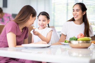 Happy asian family and having fun during eating meal together at home