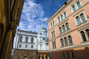 View down the street of the Helsinki Cathedral between  colorful buildings