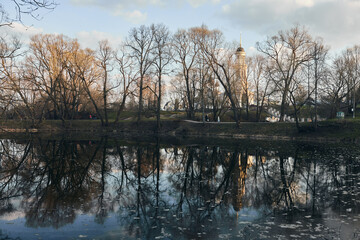 Pond in the city of Chekhov near Moscow. Sunset on the water. Manor of Lopasnya-Zachatievskoe, Russia. Front view.