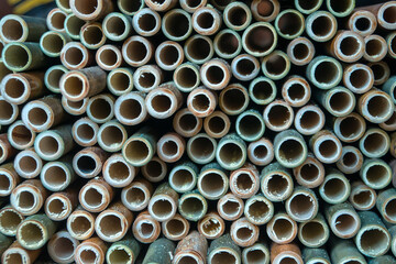 A very large pile of small bamboo, which will later be made into various crafts such as children's toys, straws, flutes, and others, the production process is done manually by local craftsmen	