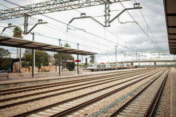 Fototapeta premium bokeh unfocused train station tracks trains clouds rails electric