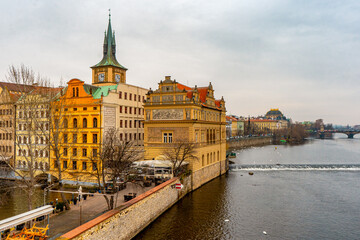 Fototapeta premium Beautiful view , buildings , cityscape from Charles bridge in Prague old town , medieval stone arch bridge along Vltava River during winter . Prague , Czech : December 12 , 2019