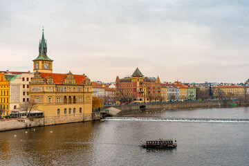 Obraz premium Beautiful view , buildings , cityscape from Charles bridge in Prague old town , medieval stone arch bridge along Vltava River during winter . Prague , Czech : December 12 , 2019