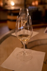 Wine tasting in underground cellars caves of French wine domain in Puligny-Motrachet village, Burgundy, France