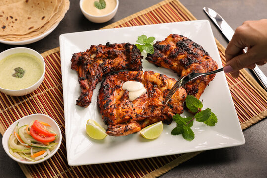 Thandoori chicken , Arabian spicy food tandoori whole chicken Bengaluru, India . Platter served with salads. Al Faham Charcoal Grilled Chicken in India .