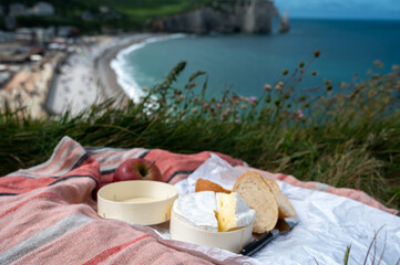 Lunch with french round camembert cow cheese from Calvados region, fresh baked baguette bread and...