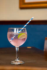 Glass of gin and tonic cocktail served in old vintage Scottisch pub, drinking gin in Edinburgh, UK