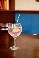 Glass of gin and tonic cocktail served in old vintage Scottisch pub, drinking gin in Edinburgh, UK