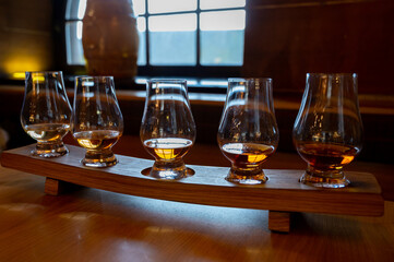 Flight of single malt scotch whisky in glasses served in whiskey bar in Edinburgh, UK