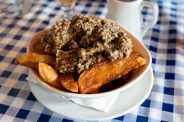 Scottish traditional snack food, hand cut potato chips topped with haggis and gravy
