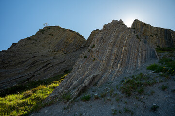 View on steeply-tilted layers of flysch on Atlantic coast at Zumaia at low tide, Basque Country, Spain