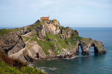 Fototapeta na wymiar Stone footpath to famous landmark and film location in North of Spain, ocean islet with chapel San juan de gaztelugatxe, Basque Country, Spain