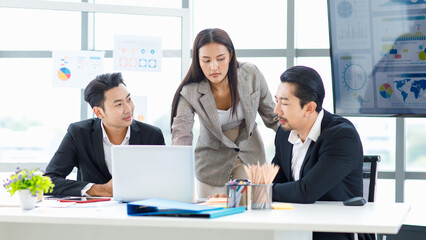 Millennial Asian cheerful happy professional successful male businessman and female businesswoman colleague in formal suit smiling brainstorming discussing talking in company office meeting room.