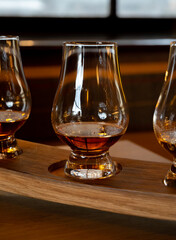 Flight of single malt scotch whisky in glasses served in whiskey bar in Edinburgh, UK